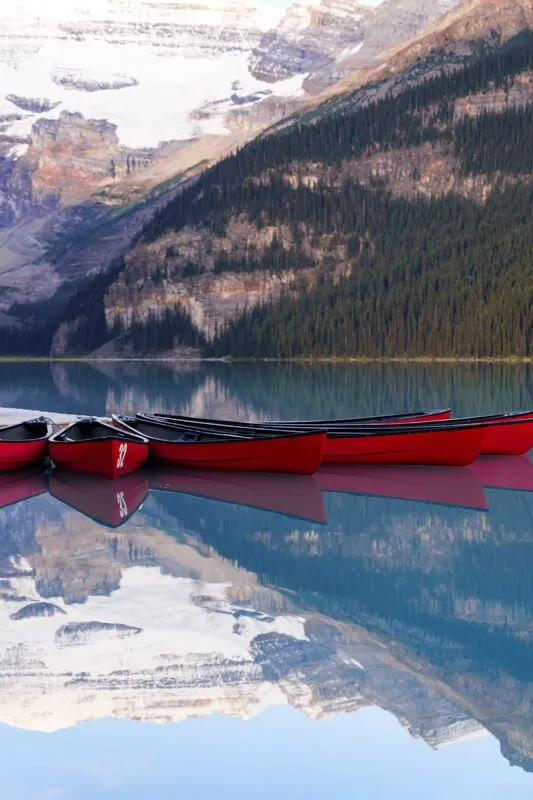 Lake Louise Canoe Banff | Adventure Photographer Portfolio Red canoe on lake with mountains