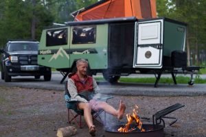 Sheridan enjoying a fire with taxa outdoors camper in Yellowstone national park