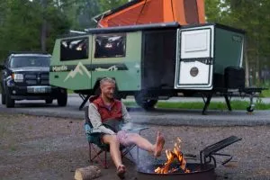 Sheridan enjoying a fire with taxa outdoors camper in Yellowstone national park
